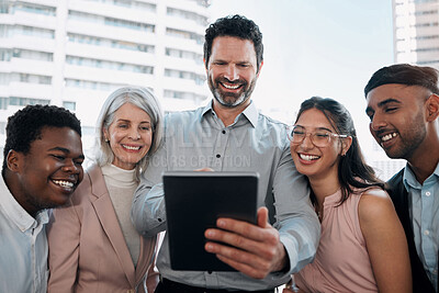 Buy stock photo Shot of a diverse group of businesspeople standing in the office together and using a digital tablet