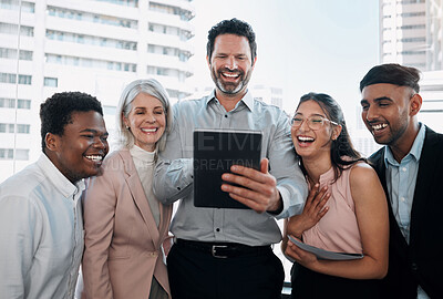 Buy stock photo Shot of a diverse group of businesspeople standing in the office together and using a digital tablet