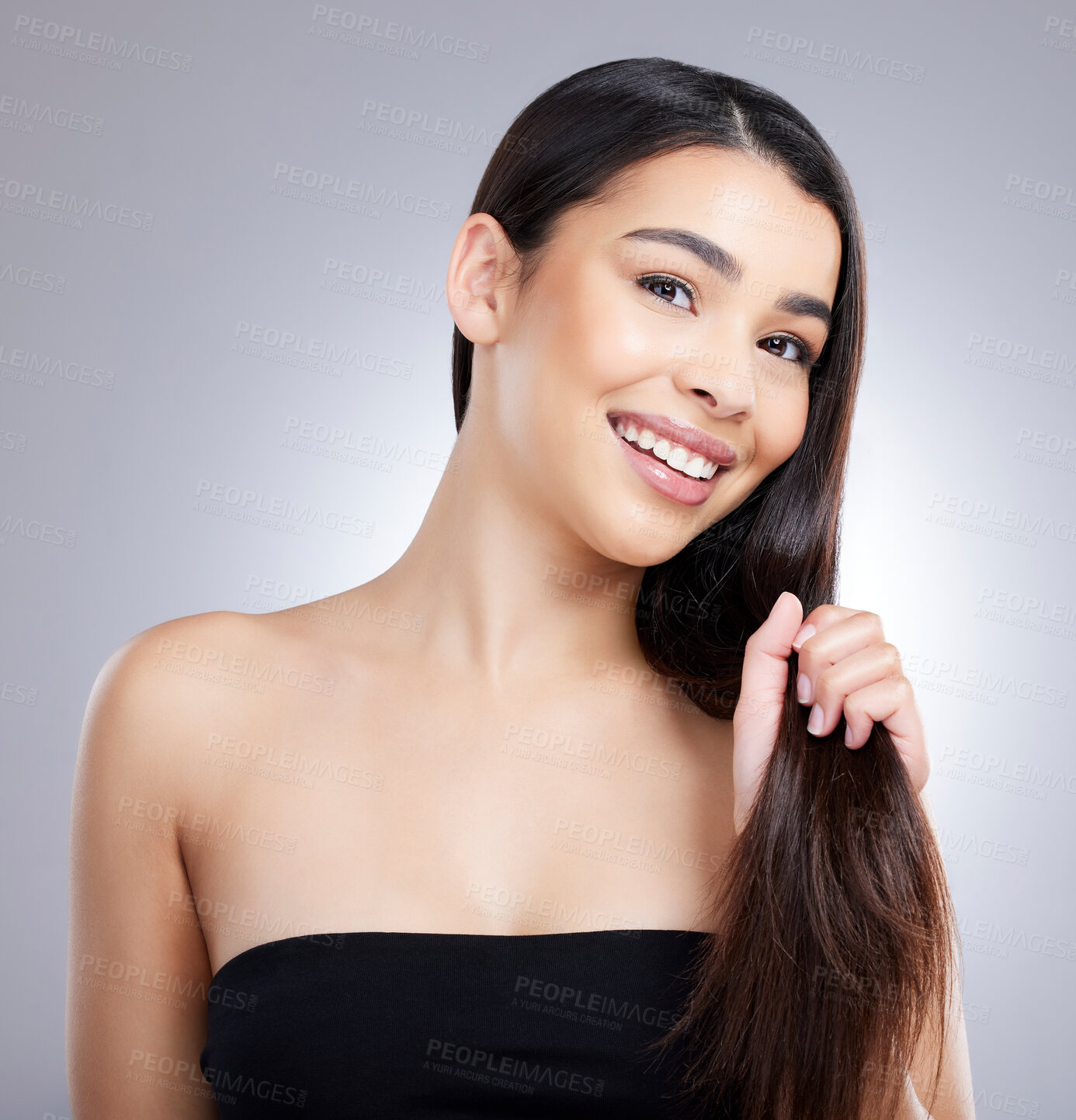 Buy stock photo Studio portrait of an attractive young woman posing against a grey background