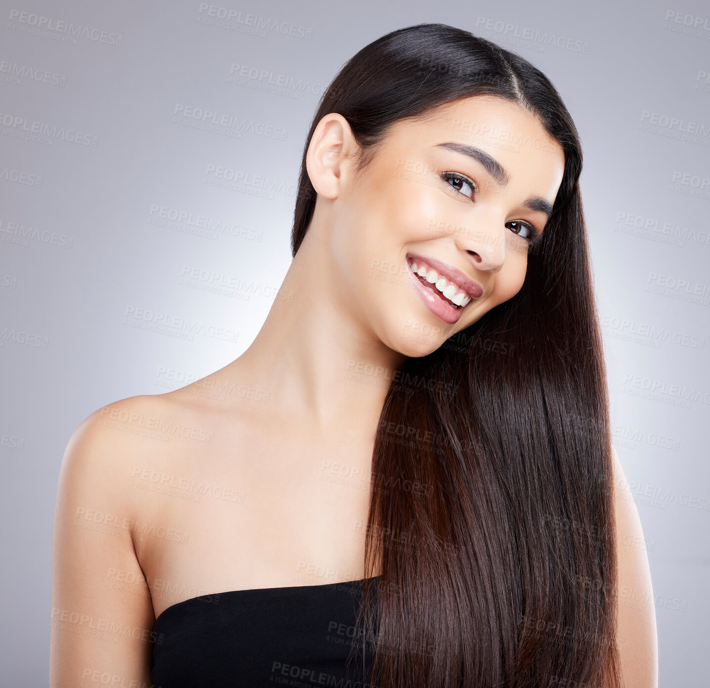 Buy stock photo Studio portrait of an attractive young woman posing against a grey background