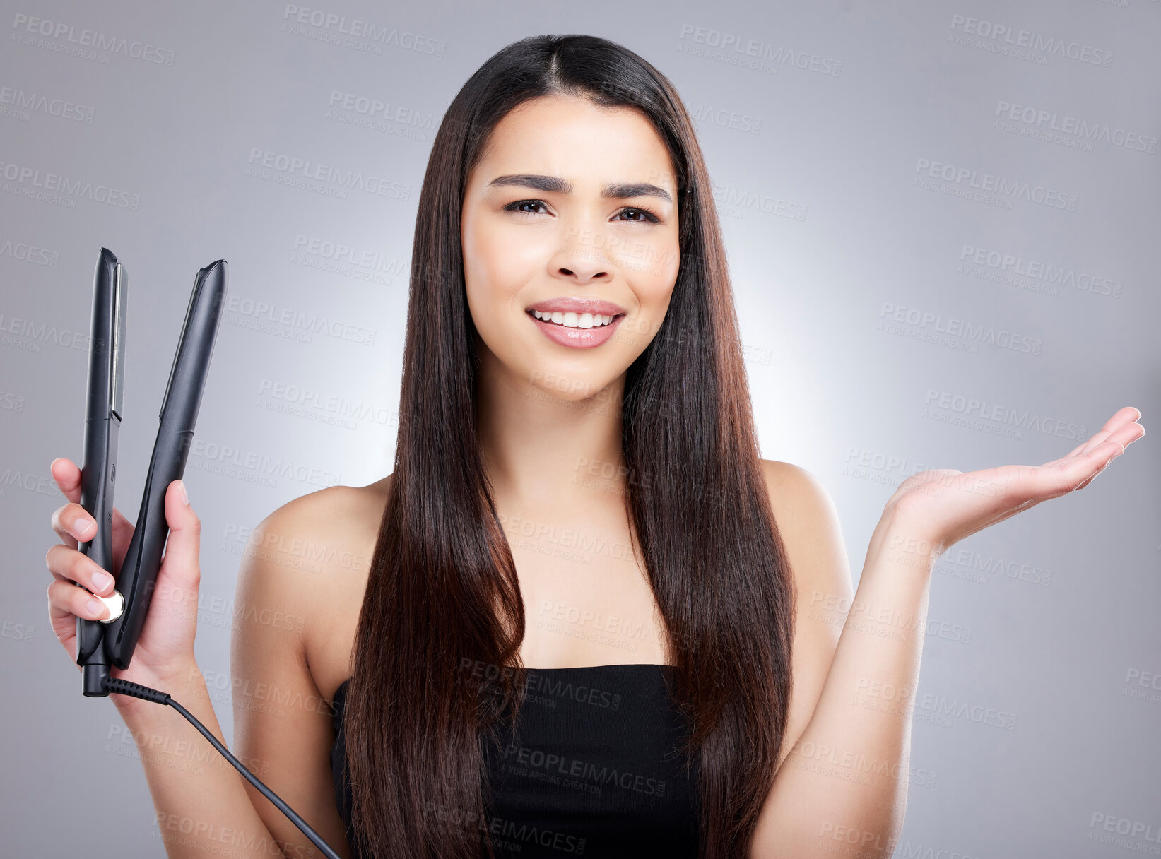 Buy stock photo Portrait, flat iron and confused woman in studio for hair care, keratin treatment or cosmetics on gray background. Salon, beauty and model with doubt for grooming, texture or electric straightener