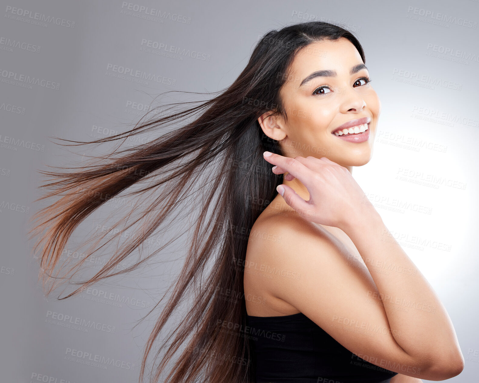 Buy stock photo Woman, happy and portrait in studio for hair care with wind, natural makeup and organic cosmetics for healthy growth. Girl, straight and salon repair on grey background, isolated and keratin.