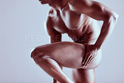 Buy stock photo Shot of an unrecognizable  muscular man posing nude against a grey background