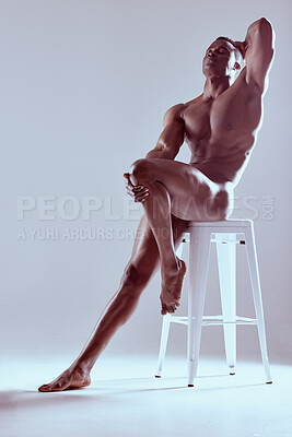 Buy stock photo Shot of a muscular young man posing nude against a grey background