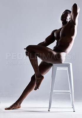 Buy stock photo Shot of a muscular young man posing nude against a grey background