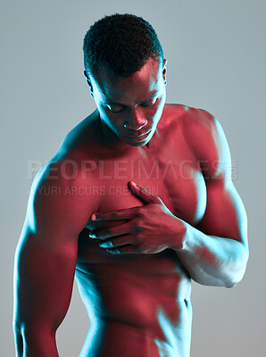 Buy stock photo Shot of a muscular young man posing nude against a grey background