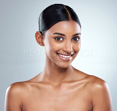 Buy stock photo Cropped portrait of an attractive young woman posing in studio against a grey background