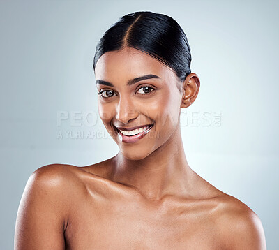 Buy stock photo Cropped portrait of an attractive young woman posing in studio against a grey background