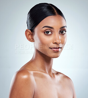 Buy stock photo Cropped portrait of an attractive young woman posing in studio against a grey background