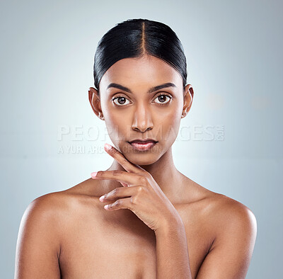 Buy stock photo Cropped portrait of an attractive young woman posing in studio against a grey background