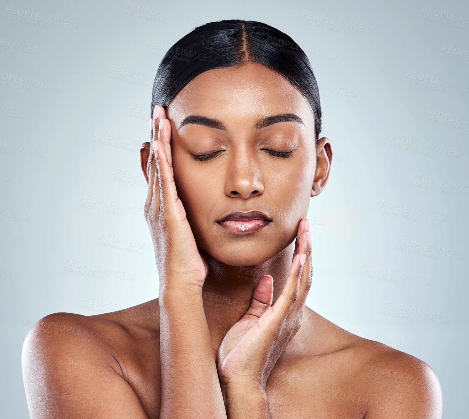 Buy stock photo Beauty, makeup and face of Indian woman on a white background for cosmetics, wellness and skincare. Dermatology, cosmetology and person with hands for health, salon and facial treatment in studio