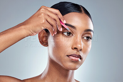 Buy stock photo Cropped shot of an attractive young woman posing in studio against a grey background