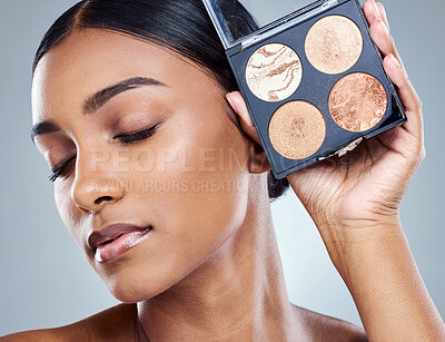 Buy stock photo Woman, makeup palette and beauty with eyes closed in studio for wellness, face and product for brand. Female person, cosmetology and pride with eyeshadow or blush for dermatology in studio background