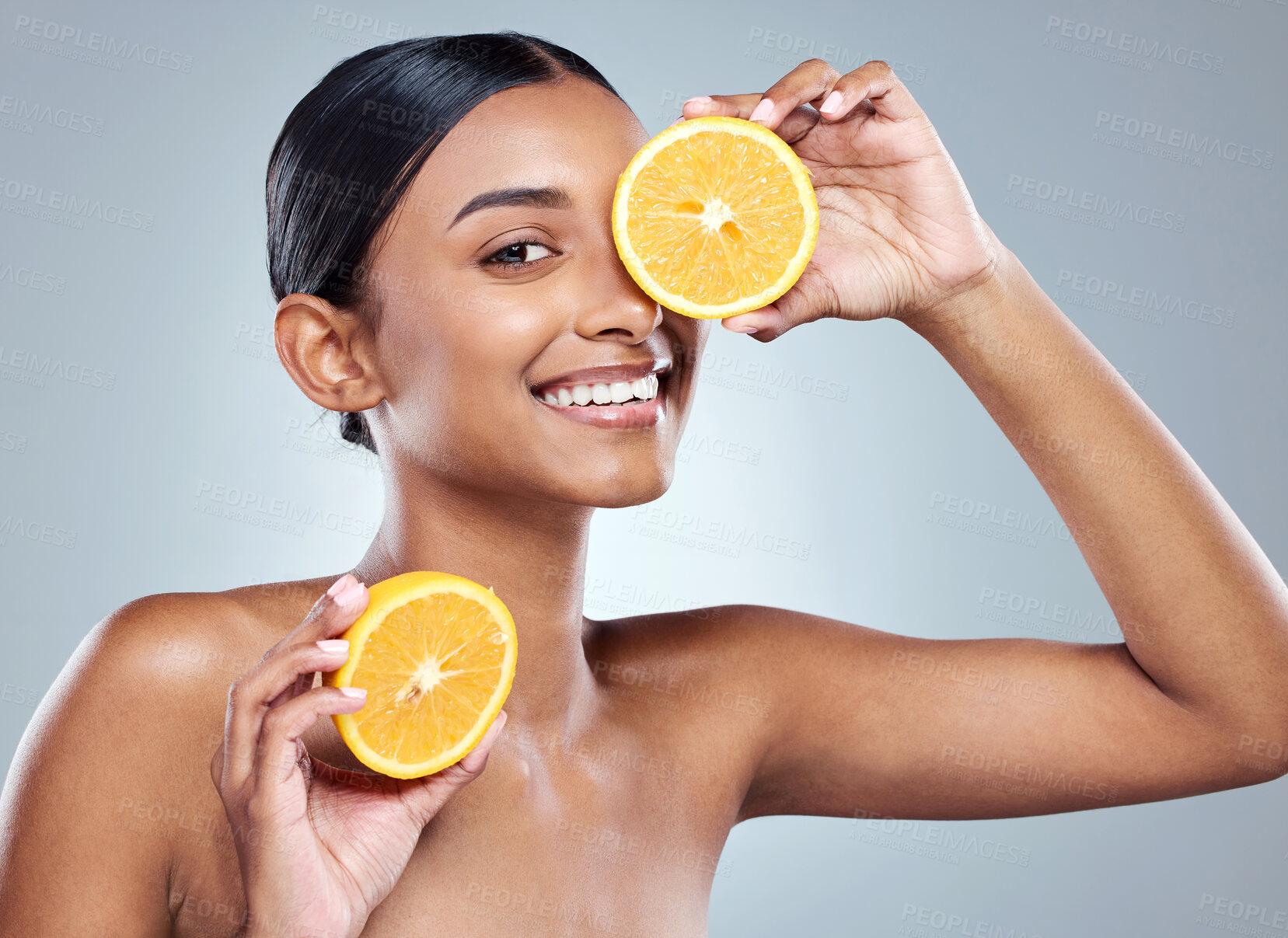 Buy stock photo Indian woman, orange and smile for organic beauty, hand and fruit on white background. Citrus, face or vitamin c for hydrated skin or body care, studio and vegan skincare with happy female person