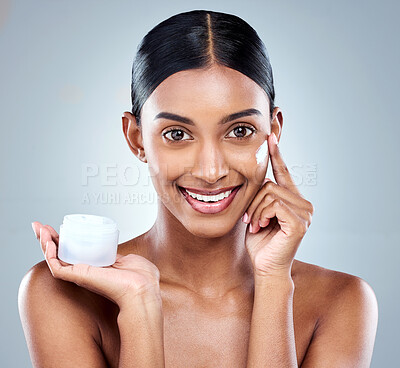 Buy stock photo Cropped portrait of an attractive young woman posing in studio against a grey background