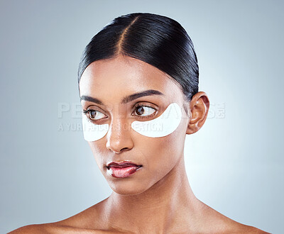 Buy stock photo Indian woman, face and eye patch for beauty and skincare, hydration and refresh on white background. Thinking, dermatology and facial treatment for collagen, detox and serious female person in studio