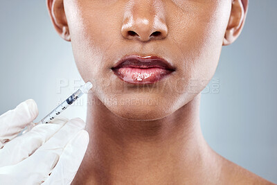 Buy stock photo Closeup shot of an unrecognizable young woman posing in studio against a grey background