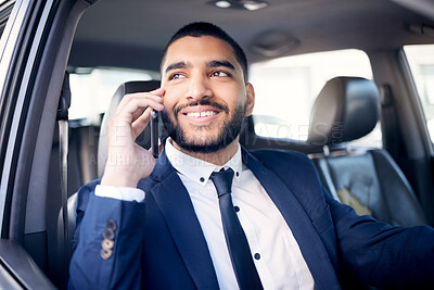 Buy stock photo Shot of a young businessman talking on a cellphone while driving a car