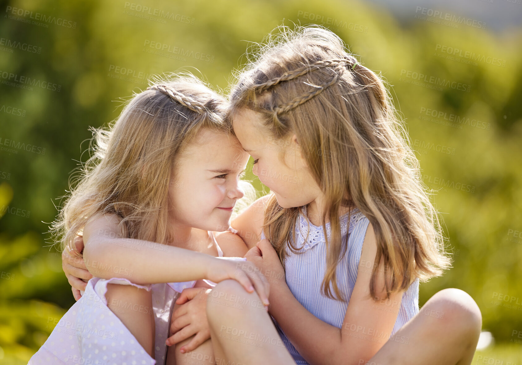 Buy stock photo Girl, sisters and hug with care in garden with smile, love and playful in sunshine on holiday. Kids, siblings and happy with embrace, connection and bonding in backyard, nature or outdoor in Germany