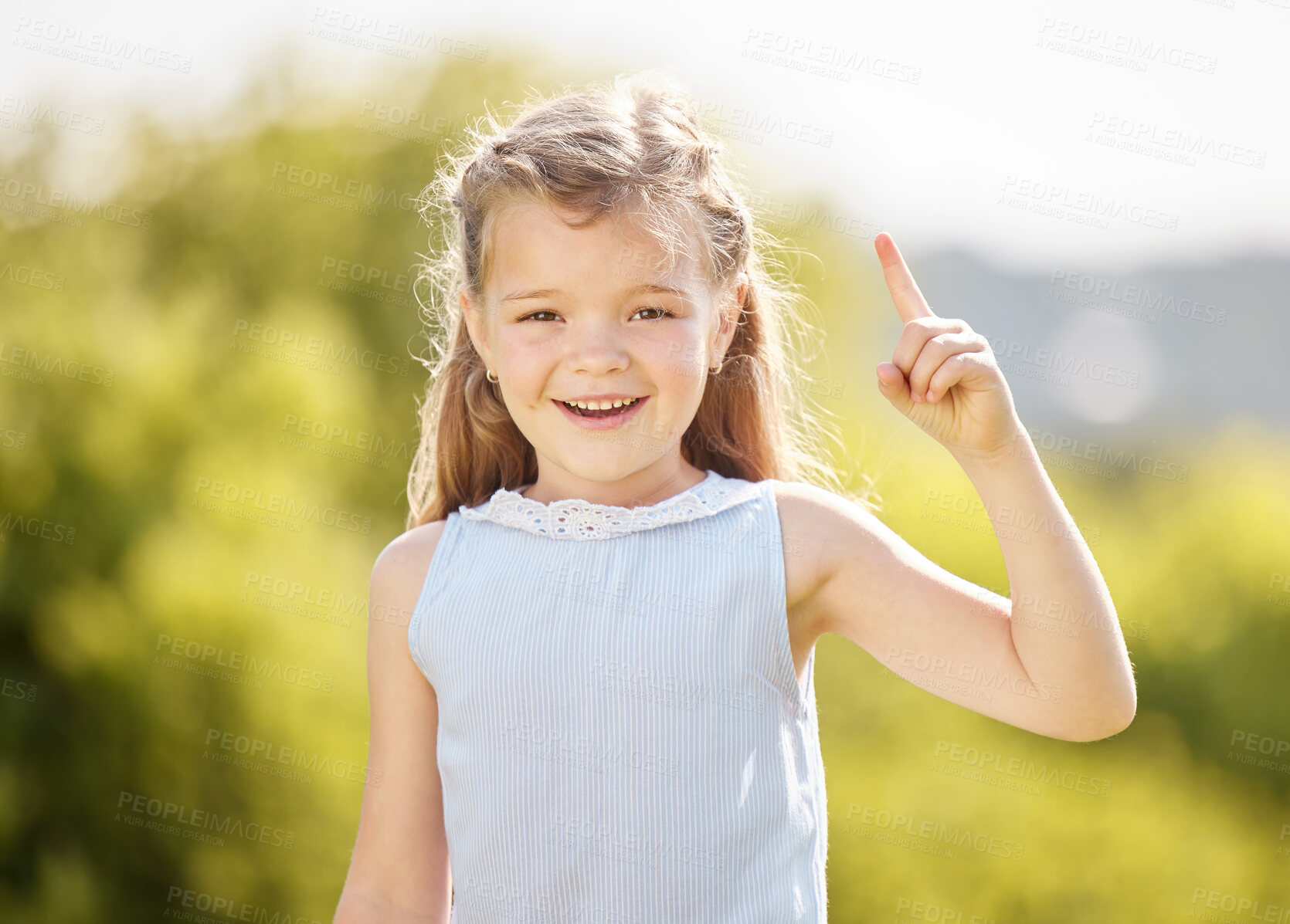 Buy stock photo Happy, pointing and portrait of child in park with smile for playing, childhood and adventure outdoors. Nature, mockup and young girl with hand gesture for direction, signal and excited in playground