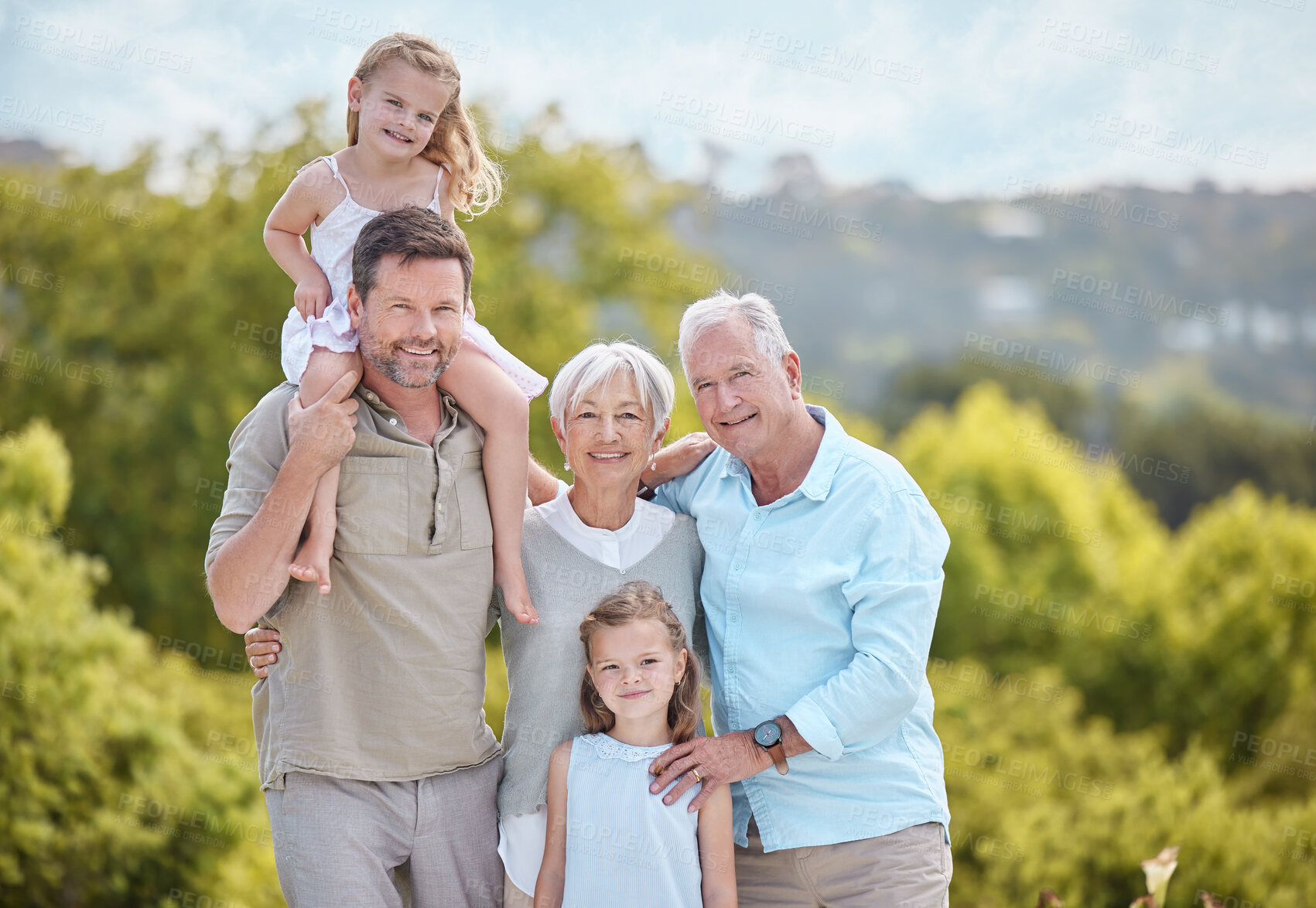 Buy stock photo Shot of a family standing together in a park