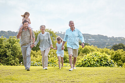 Buy stock photo Shot of a family walking together in a park