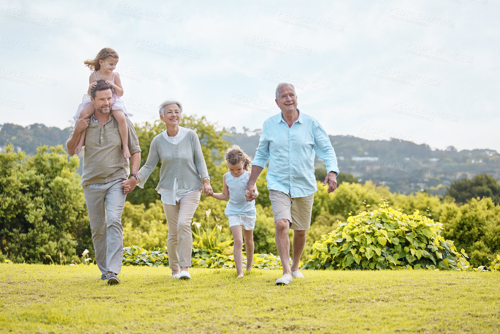 Buy stock photo Family, generations and holding hands in park with kids, smile and outdoor fun on weekend morning together. Grandparents, dad and girl children in garden for happy bonding, relax and love in nature