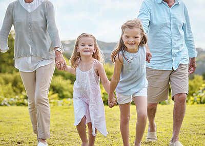Buy stock photo Shot of an affectionate mature couple and their granddaughters in a park