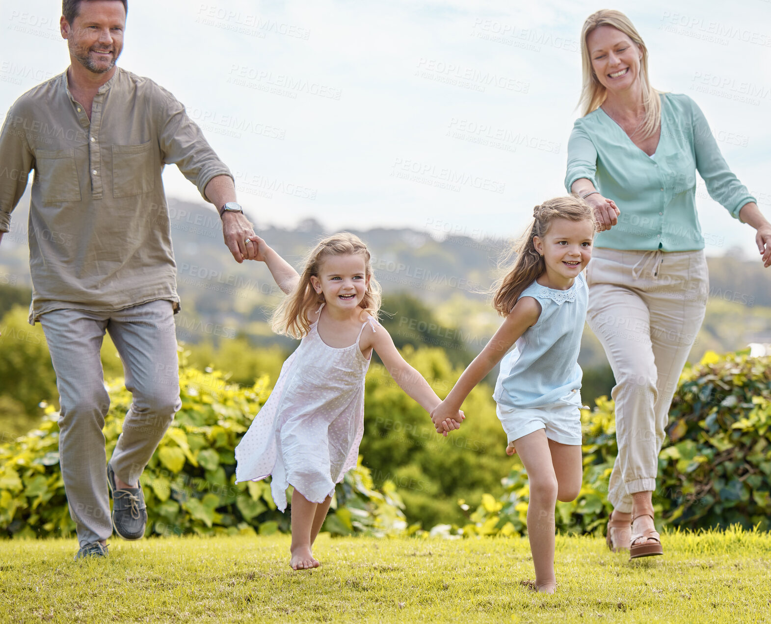 Buy stock photo Parents, running and girl kids holding hands with smile, outdoor fun and weekend morning bonding together. Mother, father and children in garden for happy family, energy and love on grass in nature.