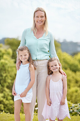 Buy stock photo Shot of a woman spending time outdoors with her two daughters
