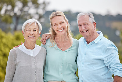 Buy stock photo Shot of a woman standing with her parents in a park