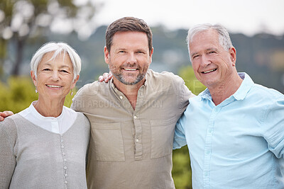 Buy stock photo Shot of a man standing with his parents in a park