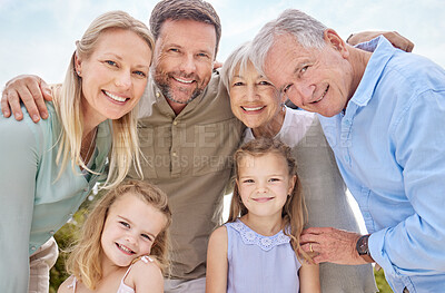 Buy stock photo Shot of a multi-generational family standing together outside