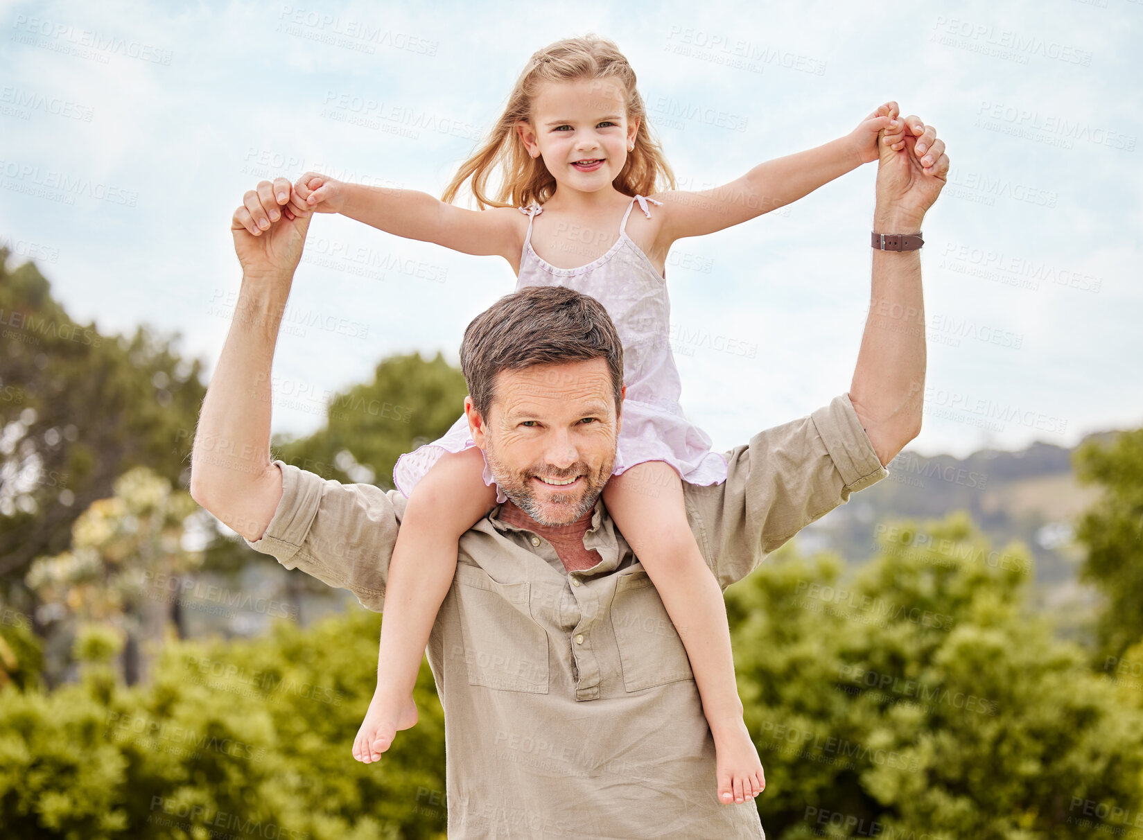 Buy stock photo Shot of a father spending time outdoors with his young daughter