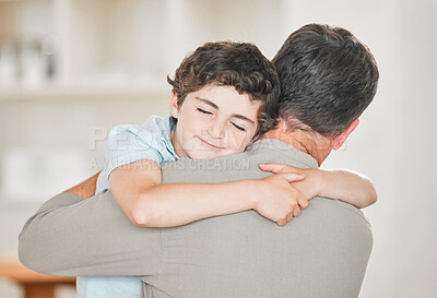 Buy stock photo Cropped shot of an adorable little boy embracing his dad lovingly at home