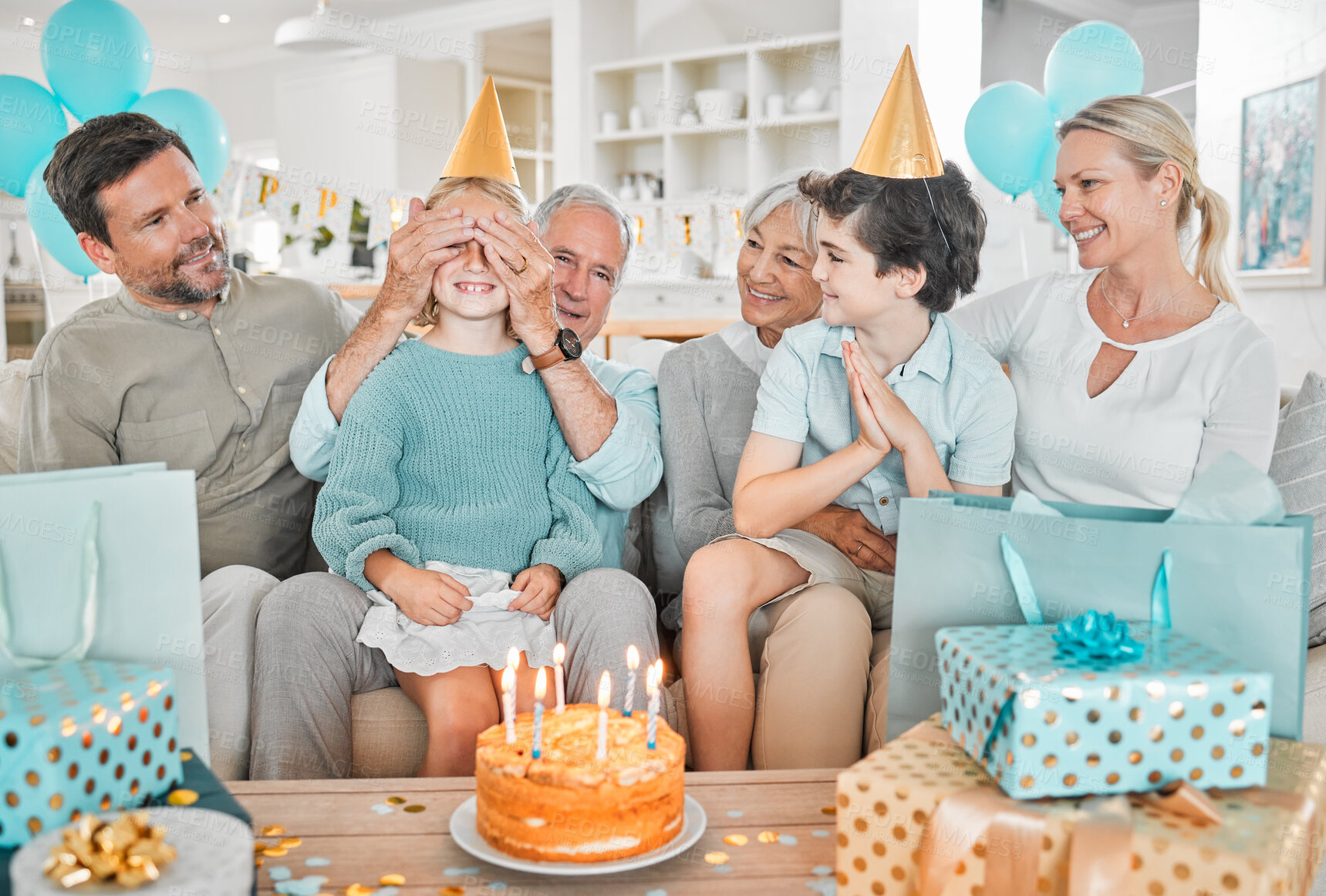 Buy stock photo Cropped shot of a happy family celebrating a birthday together at home