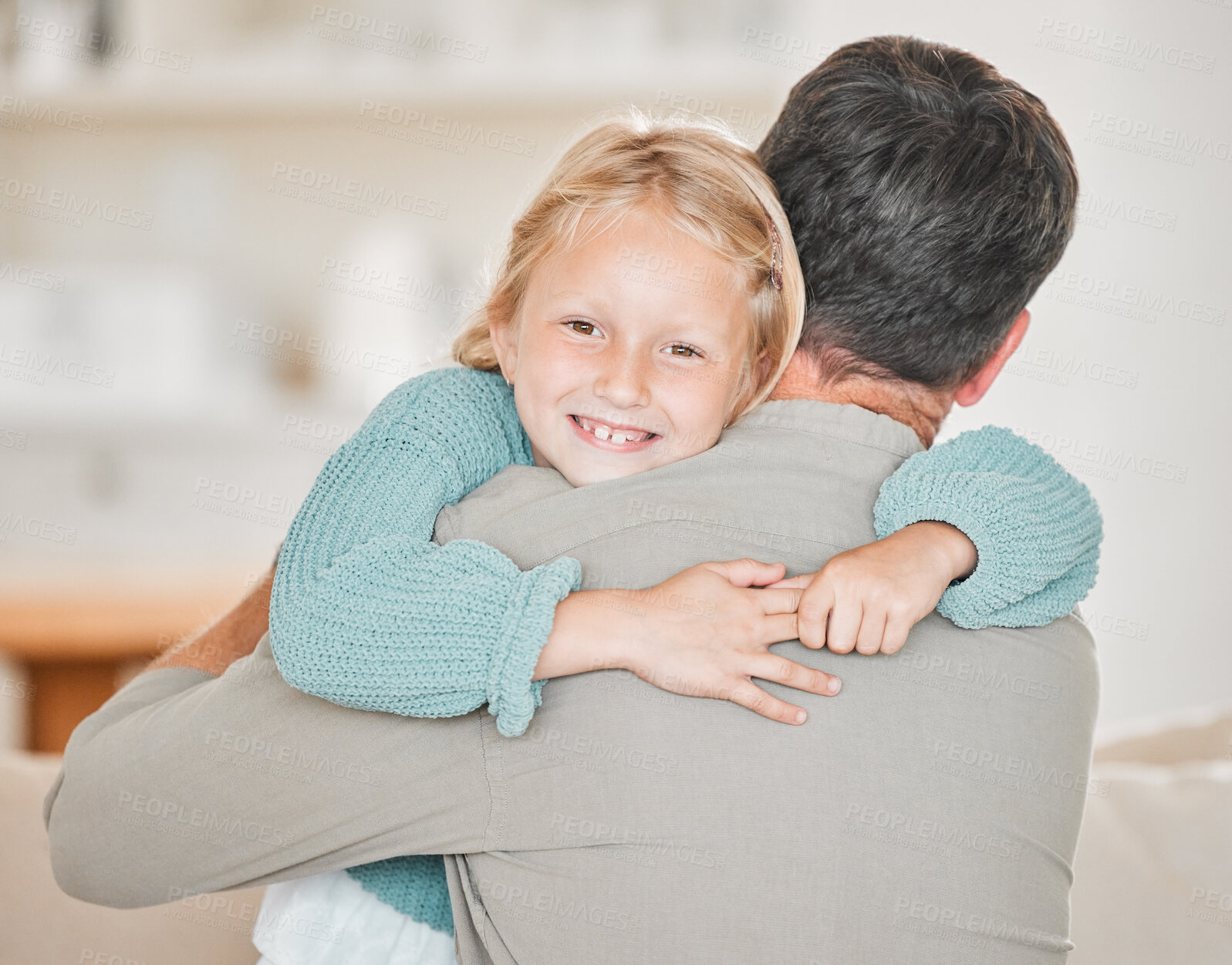 Buy stock photo Smile, child and hug father in home for love, care or bonding together in living room. Happy girl, kid and embrace dad for support, safety or connection with parent for healthy relationship of family