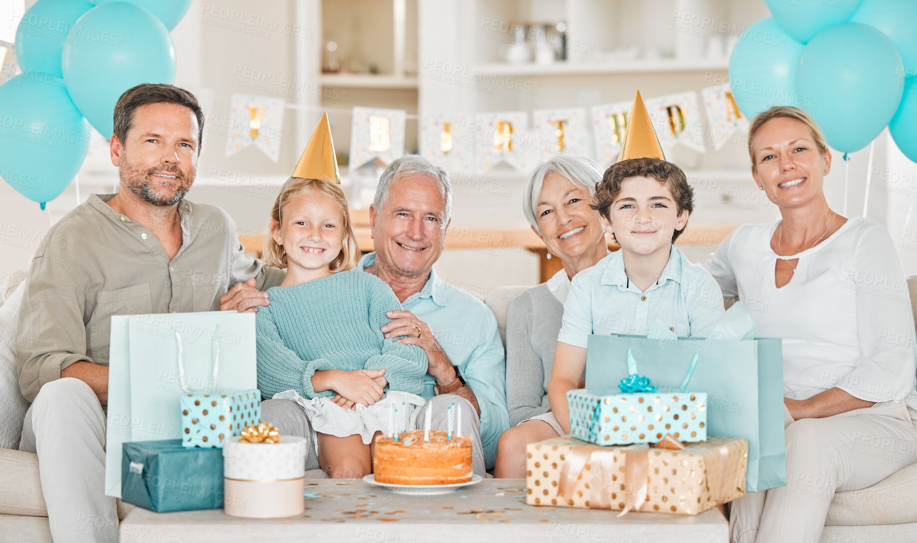 Buy stock photo Big family, children and portrait on sofa for birthday cake with party, candles and celebration with gift in home. Parents, grandparents and kids with present, excited and dessert with event in Spain