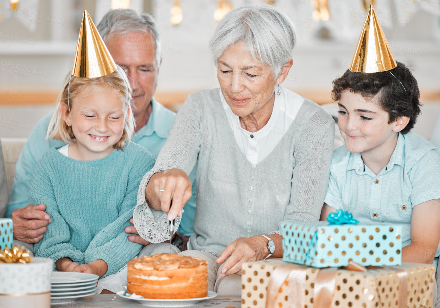 Buy stock photo Grandmother, children and cutting with birthday cake, family or excited for celebration with bonding in home. Senior woman, kids and grandfather for dessert, presents or connection with love in house