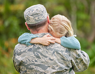 Buy stock photo Shot of a father returning from the army hugging his daughter outside