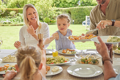 Buy stock photo Shot of a family enjoying sunday lunch together on their patio