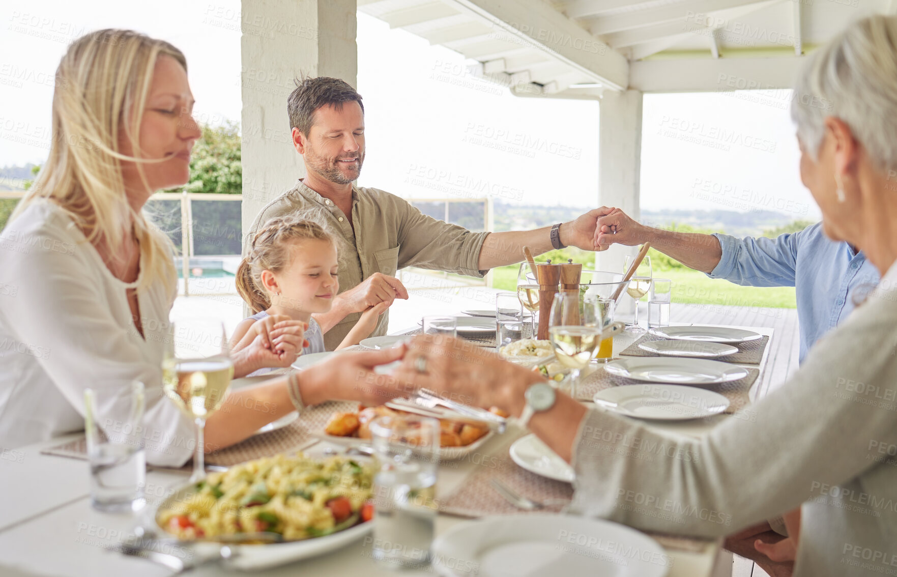 Buy stock photo Praying, group and faith for food, holding hands and together for thanksgiving, worship and respect. Home, people and praise for meal with child, gratitude and parents with kid and dinner for family
