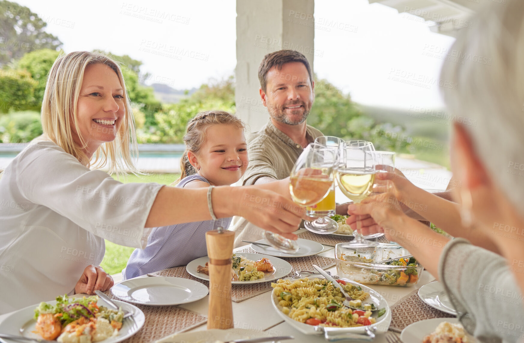 Buy stock photo Happy family, lunch and toast with wine glass in home patio outdoor to celebrate thanksgiving. Parents, grandparents and kids cheers with drinks, food and generations at social gathering on holiday