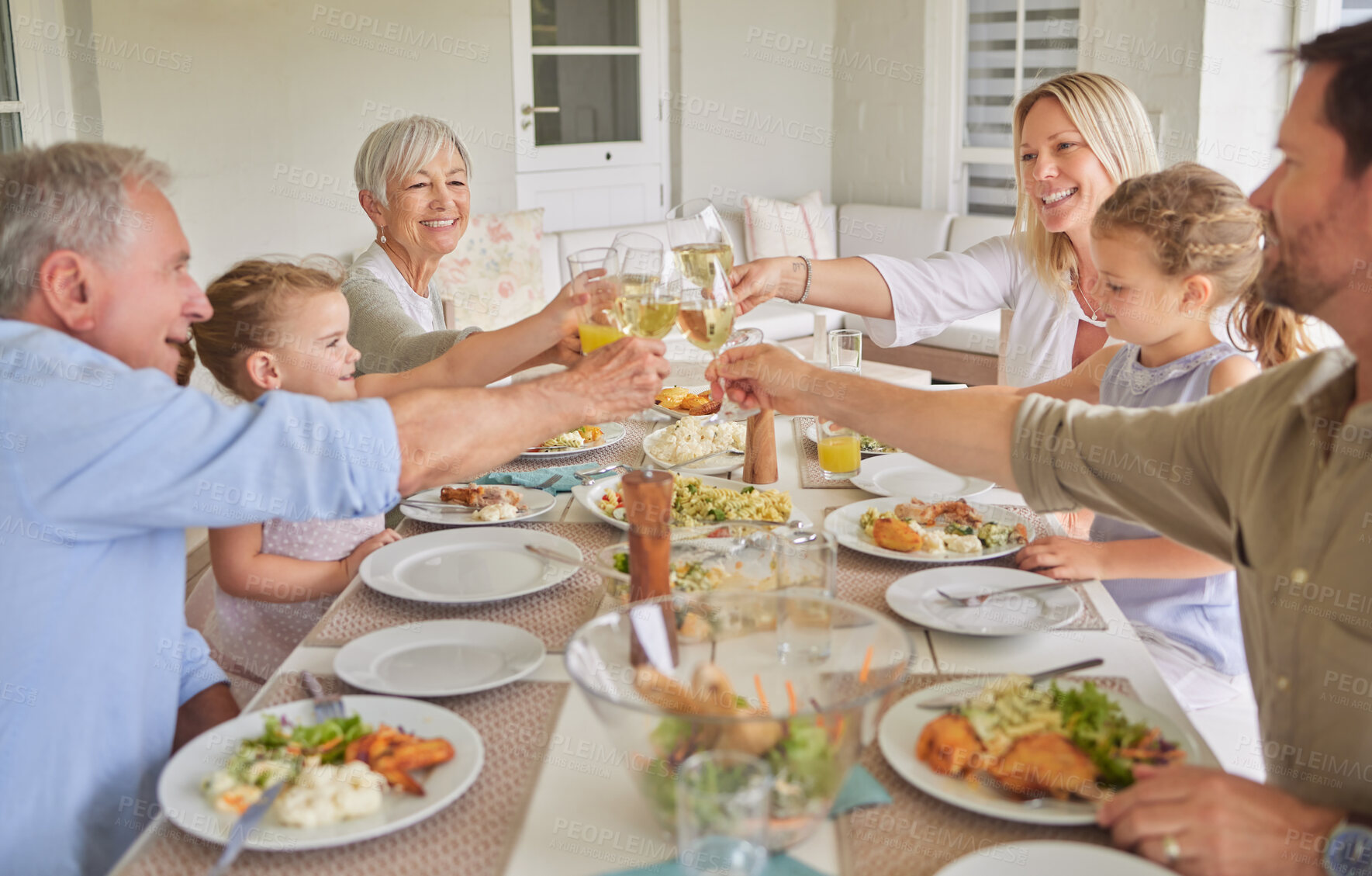 Buy stock photo Happy family, dinner and toast with wine glass in home for thanksgiving celebration. Parents, grandparents and children cheers with drinks, food or generations at social gathering on holiday together