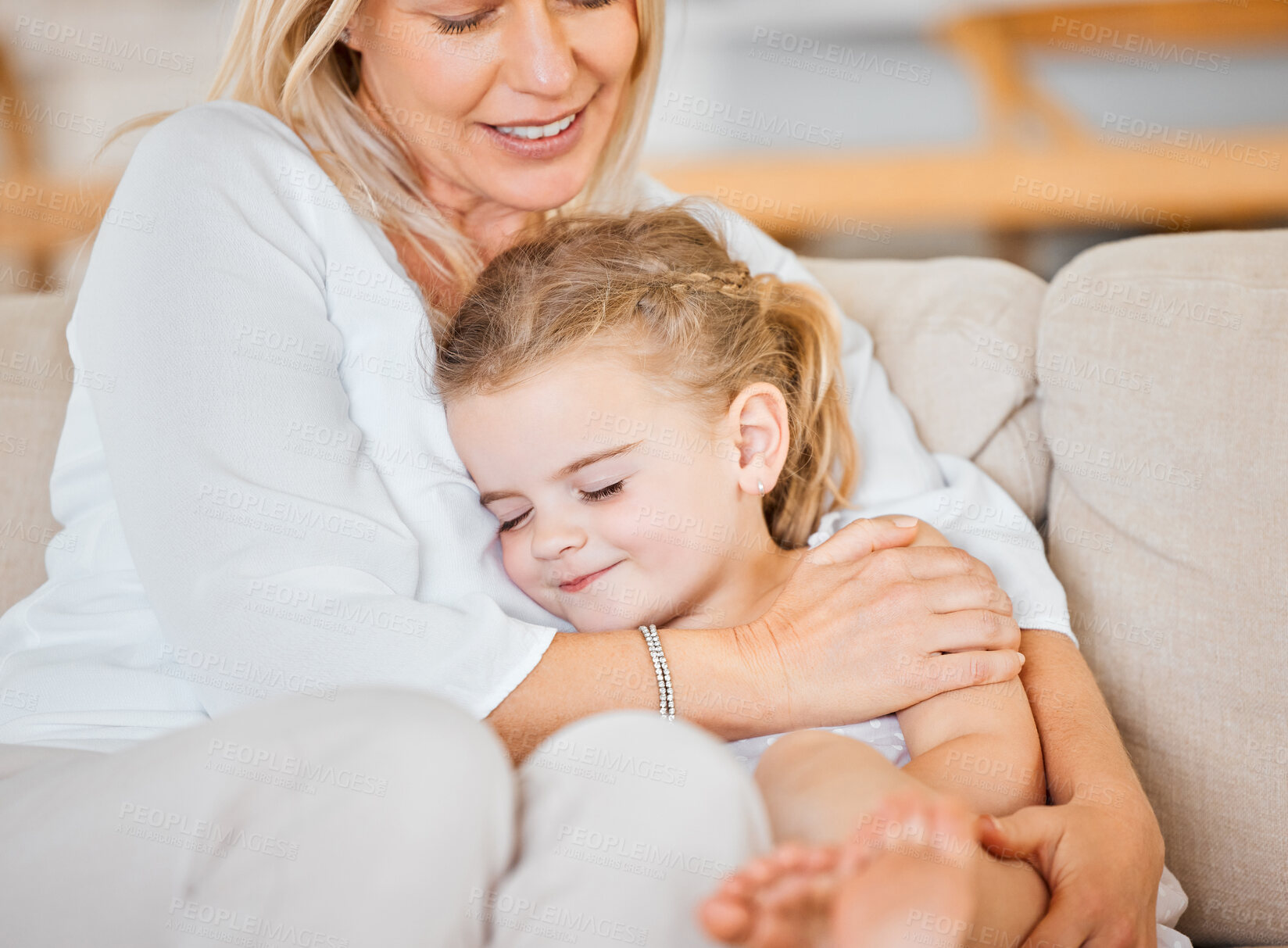 Buy stock photo Mother, happy and daughter on sofa for hug, bonding and love in home with support, care and trust. Family, girl and woman on couch in living room for embrace, relax and smile on weekend with comfort