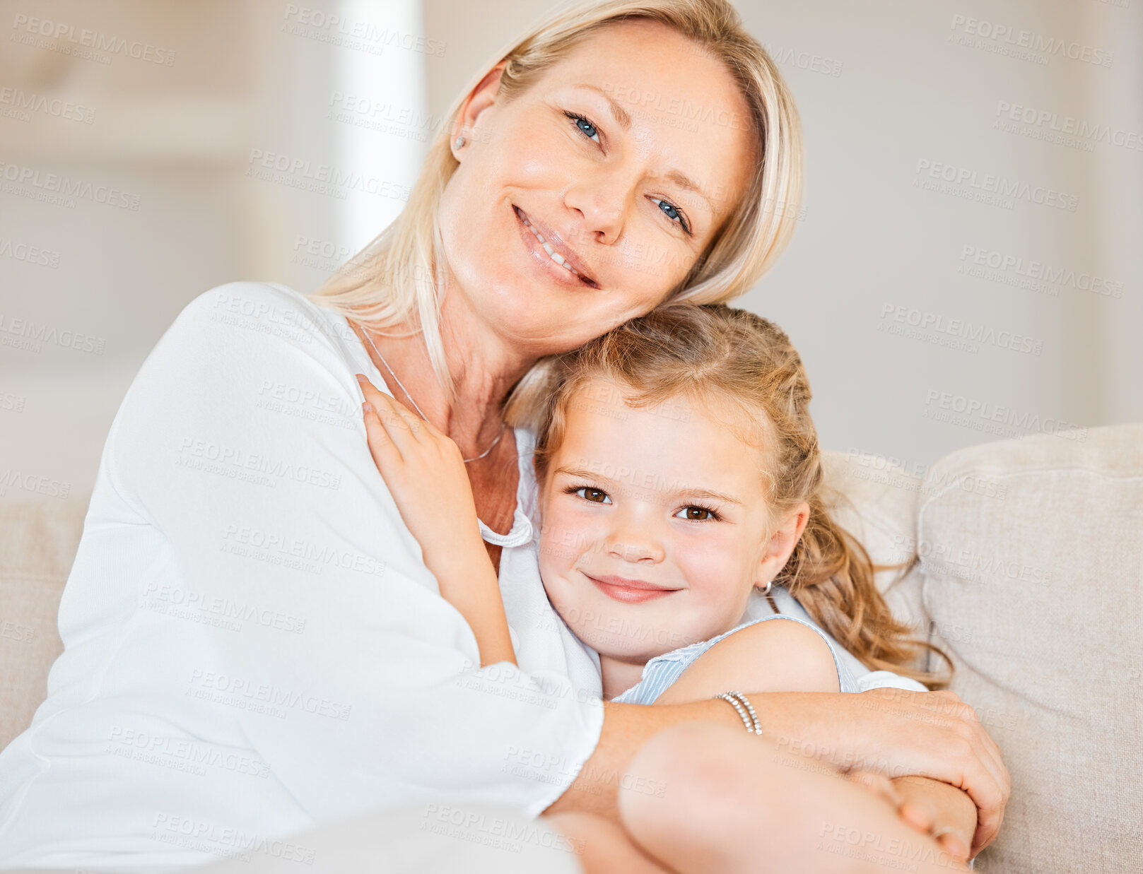 Buy stock photo Mother, portrait and daughter on sofa for hug, bonding and love in home with support, care and trust. Family, girl and face on couch in living room for embrace, relax or smile on weekend with comfort