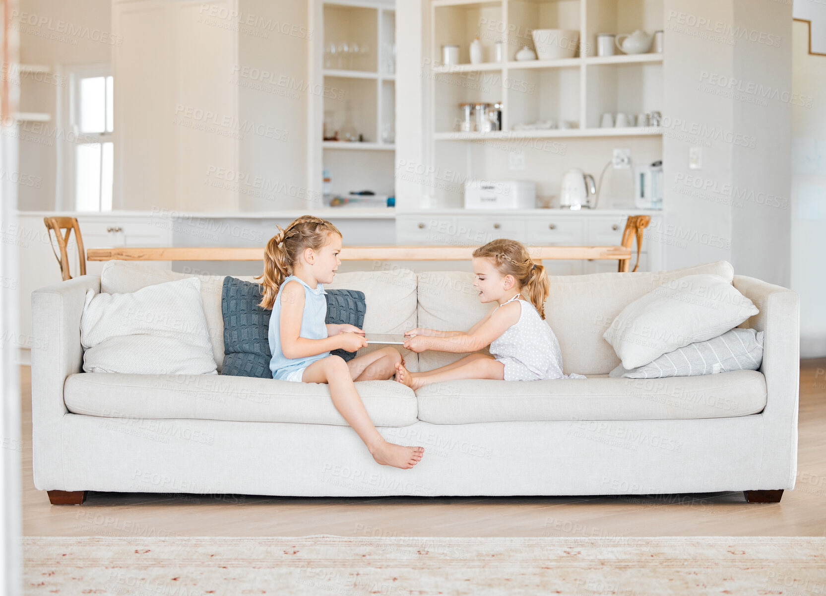 Buy stock photo Fight, children and tablet on sofa with conflict, frustrated or sharing argument in home. Sisters, kids pulling or digital tech in living room with bad behavior, bullying or sibling rivalry in lounge