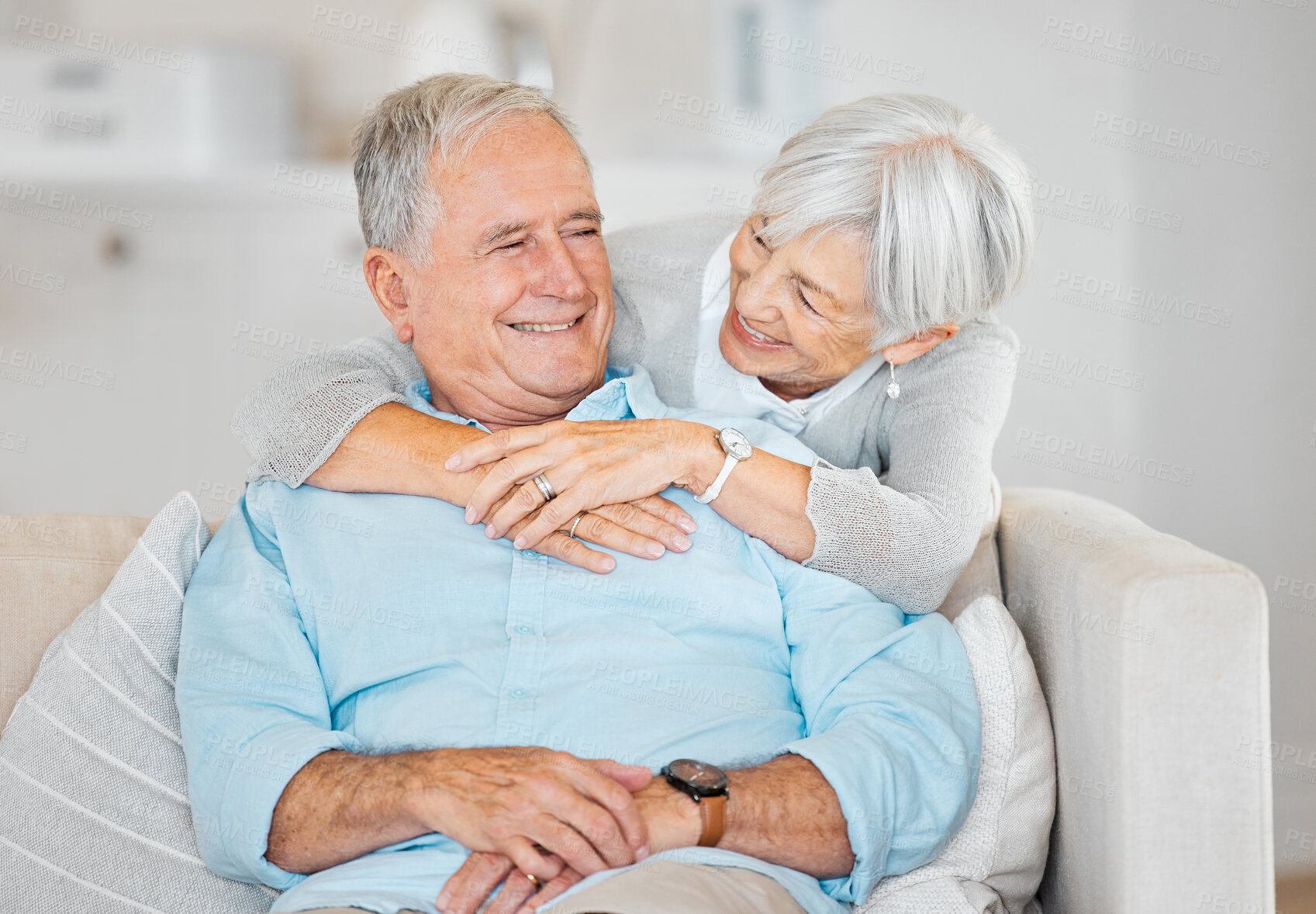 Buy stock photo Home , senior couple and happy with hugging on sofa in living room for bonding, support and retirement. People, relationship and smile at apartment of couch as pensioners with love, care and relax