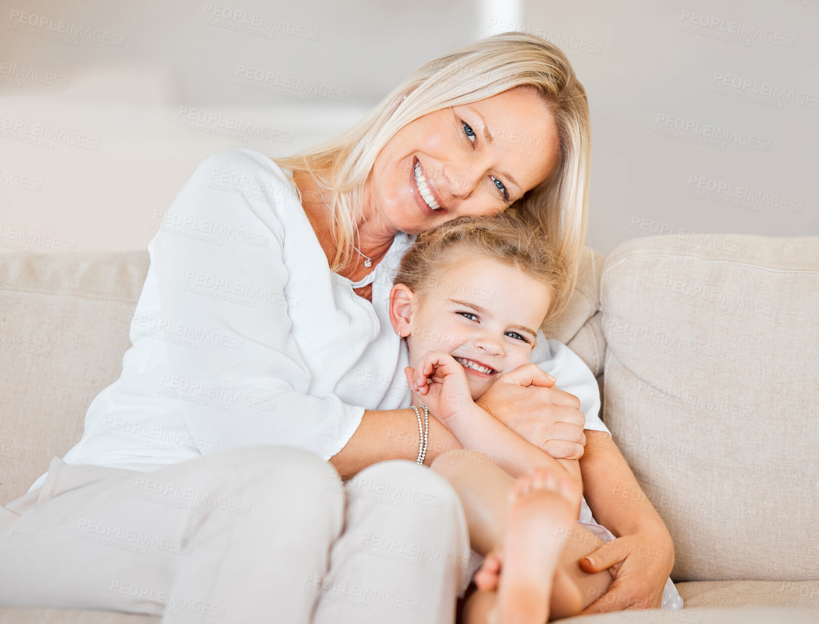 Buy stock photo Mom, portrait and daughter on sofa for hug, bonding and love in home with support, care and trust. Family, girl and happy on couch in living room for embrace, relax and smile on weekend with comfort