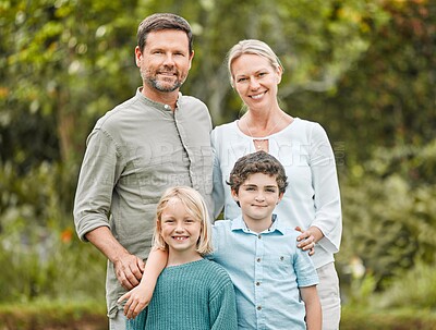Buy stock photo Shot of a couple standing outside with their two children